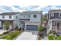 Charming two-story home with stone accents, a two-car garage, and well-maintained landscaping at 1933 Villageview Ln, Castle Rock, CO 80104