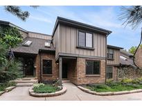Charming townhome with brick facade, gray siding and well maintained landscaping at 8236 E Phillips Pl, Centennial, CO 80112