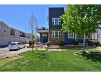 Beautiful modern home featuring a well manicured lawn, clean landscaping, and a porch balcony at 719 Robert St, Longmont, CO 80503
