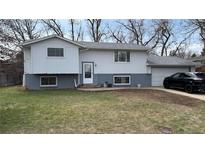 Charming two-story home with a gray exterior, lovely windows, and an attached garage at 13581 Achilles Dr, Lone Tree, CO 80124