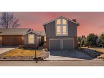 Charming two-story home featuring a two-car garage and striking window design at 11404 E Yale Pl, Aurora, CO 80014