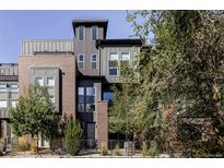 Striking modern home with a blend of brick and metal siding, and tall windows for ample natural light at 5036 S Platte River Pkwy, Littleton, CO 80123