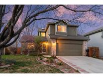 Charming two-story home with landscaped yard, brick accents, and attached two car garage at 12734 Eudora Dr, Thornton, CO 80241