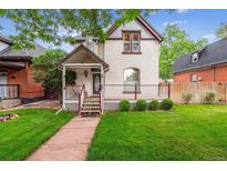 Charming home with a welcoming front porch and well-maintained lawn at 912 S Washington St, Denver, CO 80209