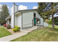 Inviting home with concrete steps, walkway, a bench, and decorative signage near the front door at 8867 Yukon St # 49, Broomfield, CO 80021