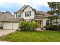 Charming two-story home with landscaped yard and attached two-car garage at 14261 W Evans Cir, Lakewood, CO 80228
