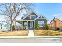 Charming two-story home with a cozy front porch, manicured lawn, and well-maintained landscaping at 5140 Mt Pawnee Ave, Frederick, CO 80504