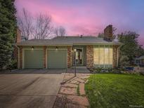 Charming single-story home featuring a brick exterior and attached two-car garage at 7872 S Hill Dr, Littleton, CO 80120