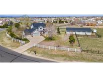 Expansive property with a large house, fenced yard, detached garage, and long driveway at 29145 E 160Th Ct, Brighton, CO 80603