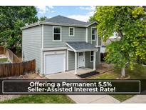 Charming two-story home with a well-maintained lawn, single car garage, and a welcoming front porch at 5225 E 100Th Dr, Thornton, CO 80229