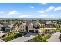 Beautiful two-story home with a three-car garage, lush landscaping, and mountain views at 5625 Heritage Oak Dr, Parker, CO 80134