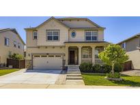 Charming two-story home with a well-manicured front yard and inviting porch at 14437 Grape St, Thornton, CO 80602
