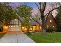 Charming brick home with a well-manicured lawn, mature trees, and a two-car garage providing great curb appeal at 6248 S Coventry Ln, Littleton, CO 80123