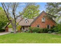 Charming brick home with a well-manicured lawn and mature trees offering curb appeal at 6248 S Coventry W Ln, Littleton, CO 80123