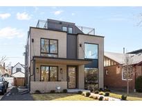 Modern two-story home with gray brick, black trim, and a rooftop deck at 872 S Vine St, Denver, CO 80209