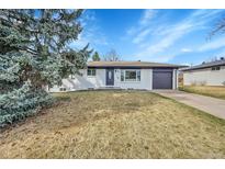 Charming single-story home featuring a well-manicured lawn and an attached garage with a driveway at 365 W Peakview Ave, Littleton, CO 80120