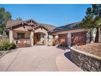 Inviting home with a stone and wood facade, paired garage doors, and manicured landscaping for great curb appeal at 2091 Ramblewood Ct, Castle Rock, CO 80104