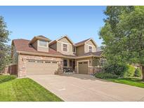 Beautiful home with a three-car garage, stone accents, and a well-manicured lawn at 15056 Fillmore Way, Thornton, CO 80602