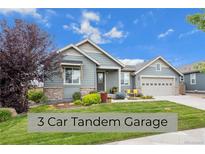 Single-story home with a 3-car tandem garage and landscaped front yard at 6845 W Evans Ave, Denver, CO 80227