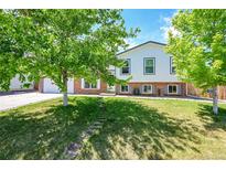 Charming two-story home with well-maintained lawn and mature trees, offering great curb appeal at 11000 Eudora Cir, Thornton, CO 80233