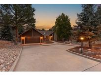 Inviting home exterior with a two-car garage and landscaping at 9724 E Villasur Ct, Parker, CO 80134