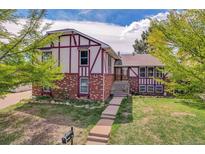 Charming two-story home with a landscaped yard and a classic brick and Tudor facade at 12341 E Cedar Cir, Aurora, CO 80012