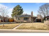 Brick ranch home with a landscaped yard and a driveway at 2885 Hudson St, Denver, CO 80207