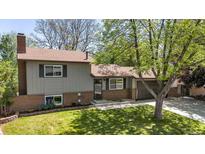 Charming home with brick accents, neutral siding, mature landscaping, and an attached two car garage at 1250 Acropolis Dr, Lafayette, CO 80026