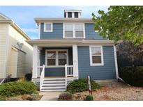 Charming two-story home featuring a welcoming front porch and professionally landscaped yard at 4689 Tanner Peak Trl, Brighton, CO 80601