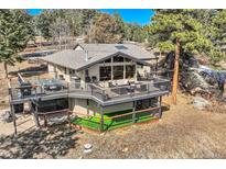 Stunning mountain home with large deck, manicured lawn, and scenic views at 21437 Alta Dr, Morrison, CO 80465