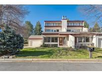 Charming two-story home featuring a lush green lawn and attached two-car garage at 2715 Northbrook Pl, Boulder, CO 80304