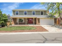 Charming two-story home with a brick facade, well-maintained lawn, and attached two car garage at 3653 E 133Rd Ct, Thornton, CO 80241