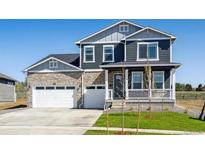 Charming two-story home with a stone facade and a well-manicured front yard at 1102 Ridgefield Dr, Berthoud, CO 80513