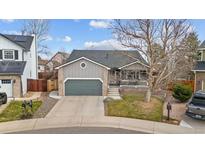Charming home with a two-car garage, covered porch, and well-maintained front yard at 3656 E 134Th Dr, Thornton, CO 80241