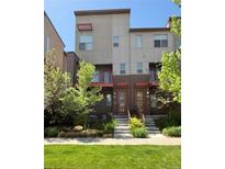 Modern townhome showcasing a contemporary design with a well-maintained lawn and landscaping in a suburban setting at 8336 E 35Th Ave, Denver, CO 80238
