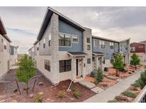 Charming townhome featuring stone accents, low maintenance yard, and modern architectural details at 9279 Merino Ct # D, Littleton, CO 80125