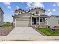 Charming two-story home featuring a covered porch, well-kept lawn, and an attached two-car garage at 42754 Calusa Pines Rd, Elizabeth, CO 80107
