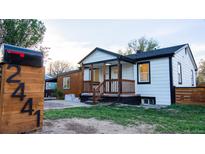 Charming home featuring fresh white siding, black trim, front porch, and easy-to-read address numbers on the mailbox at 2441 W 55Th Ave, Denver, CO 80221