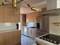 Bright kitchen featuring stainless steel appliances, light wood cabinets, and stylish countertops at 2441 W 55Th Ave, Denver, CO 80221