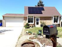 Charming single-Gathering home featuring solar panels, a brick facade, and a well-maintained front yard at 4383 S Eagle Cir, Aurora, CO 80015