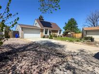 Bright house with solar panels and garage with driveway at 4383 S Eagle Cir, Aurora, CO 80015