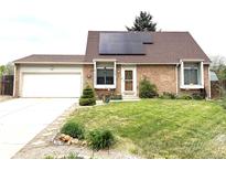 Charming brick home with solar panels and a well-manicured front yard at 4383 S Eagle Cir, Aurora, CO 80015