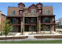 Attractive townhome with a stone facade and private balconies in a landscaped community at 9662 Browns Peak Cir, Littleton, CO 80125