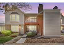 Charming townhouse with a brick chimney, a small porch, and lush landscaping in a well-maintained community at 1148 S Ventura Cir # C, Aurora, CO 80017