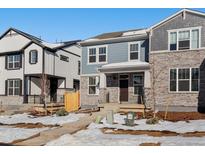 Charming two-story home featuring a mix of stone and siding, complemented by a well-manicured front yard at 773 N Tempe St, Aurora, CO 80018
