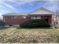 Charming brick home featuring a well-maintained front yard with lush green shrubbery at 10885 Mildred Dr, Northglenn, CO 80233