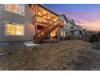 Backyard with a large deck and stairs leading to the patio below at 22658 E Tufts Ave, Aurora, CO 80015