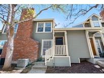 Charming home with red brick chimney, grey siding, and inviting front entry at 1981 S Hannibal Ct # B, Aurora, CO 80013