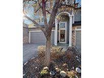 Charming two-story home featuring a well-manicured yard and attached two-car garage at 1469 S Ulster St, Denver, CO 80231