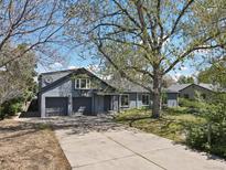 Charming home with a two-car garage and a spacious front yard, perfect for outdoor activities at 440 Balsam St, Lakewood, CO 80226
